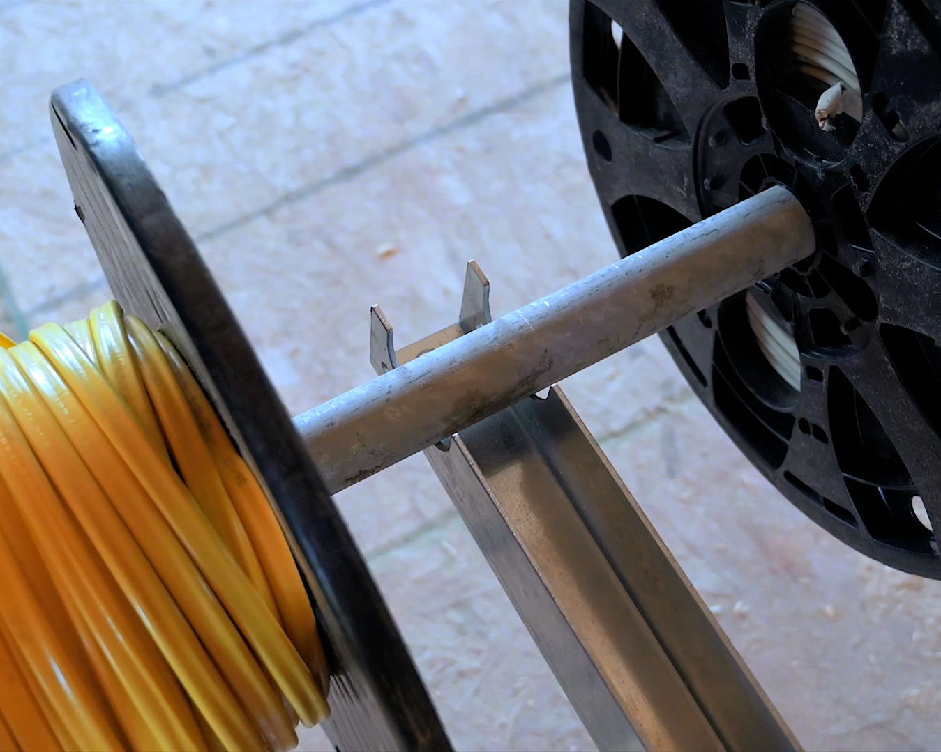 Close-up of a wire reel mounted on bracket in new construction home.
